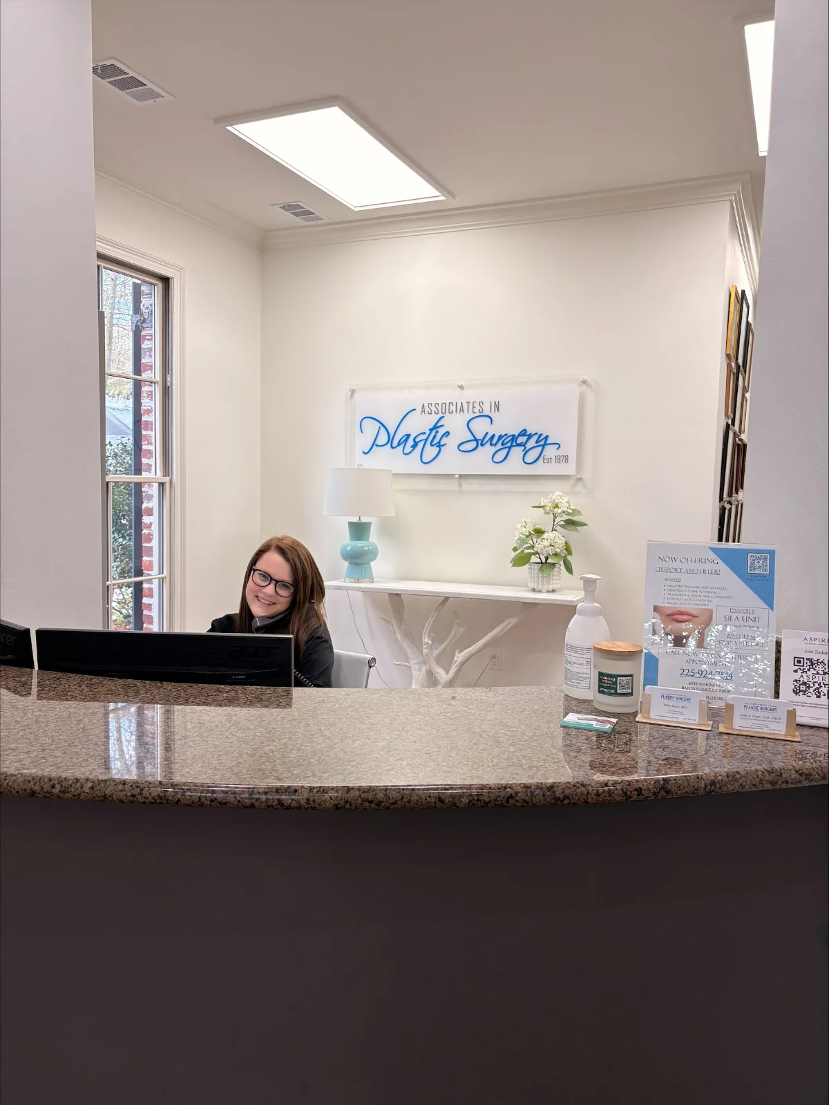 receptionist on phone behind desk